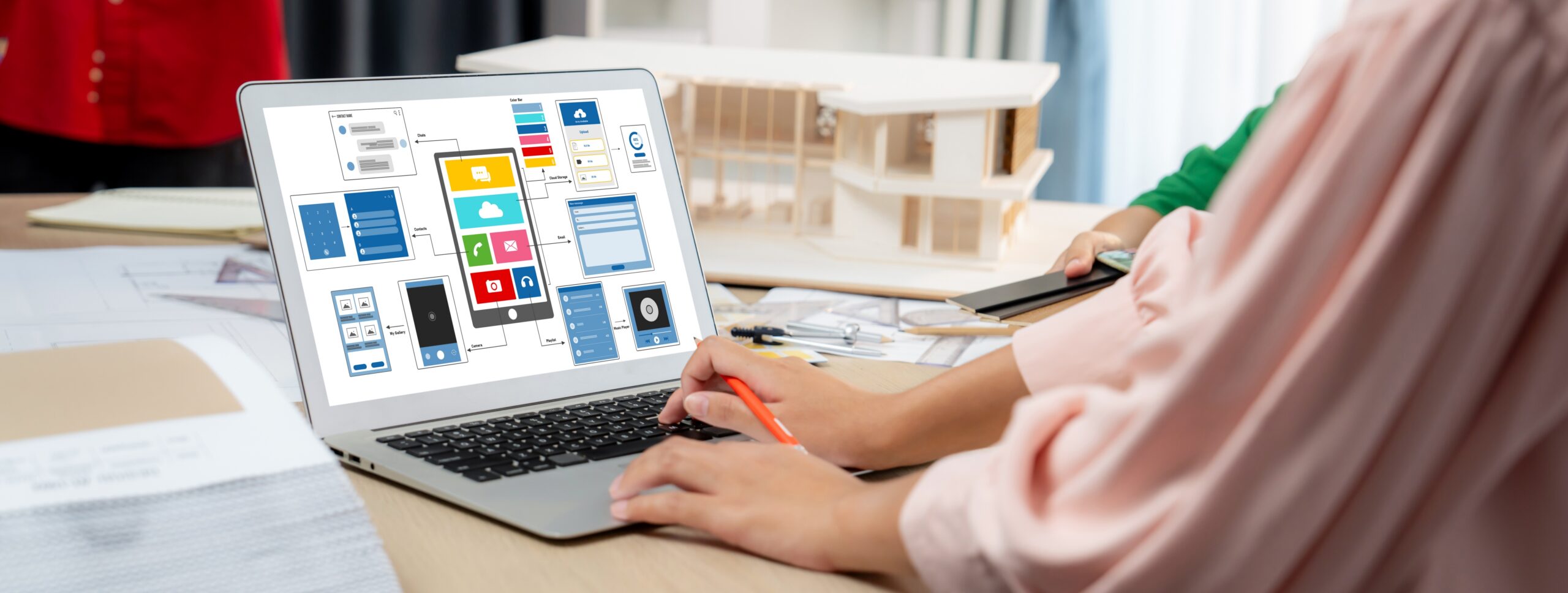 Designer team present color while laptop displayed UI and UX designs Variegated.